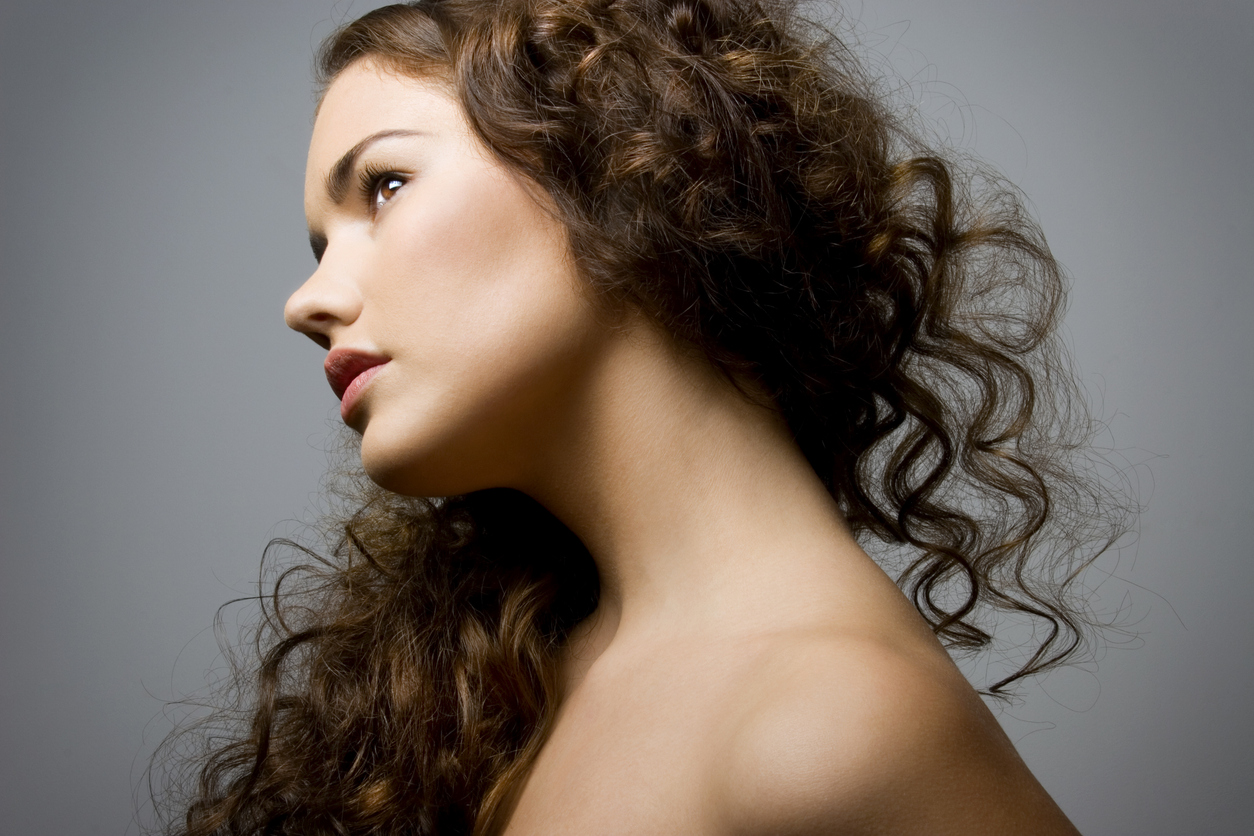 Woman with long auburn curly hair