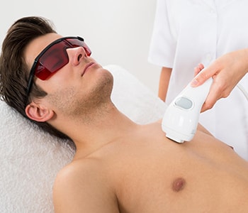 man getting laser hair removal on his chest
