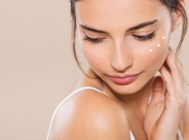 woman with moisturizer on her cheek