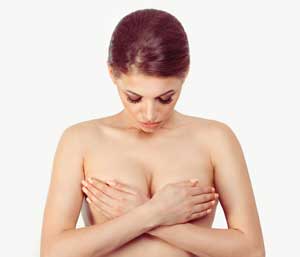 woman covering her breasts with her hands
