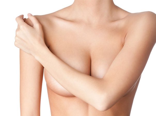 woman covering her chest with her arm
