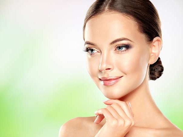 woman with blue eyes her brown hair pulled back in a low bun